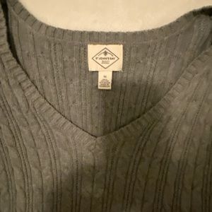 Gray cable sweater with v-neck.